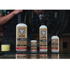 WTB TCS sealant being poured into a bicycle tire, demonstrating its use in a tubeless setup.

