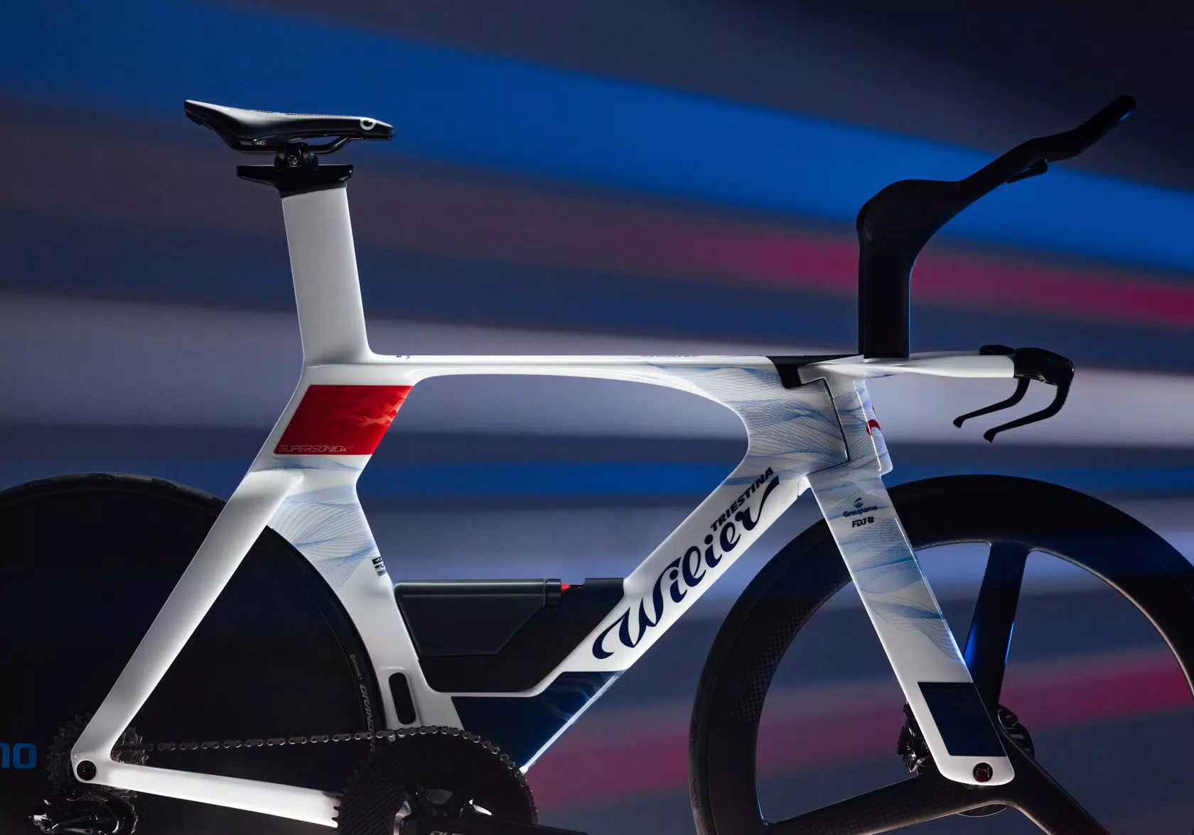 Wilier Supersonica SLR triathlon bike with white, red, and blue accents, showcasing its aerodynamic frame.