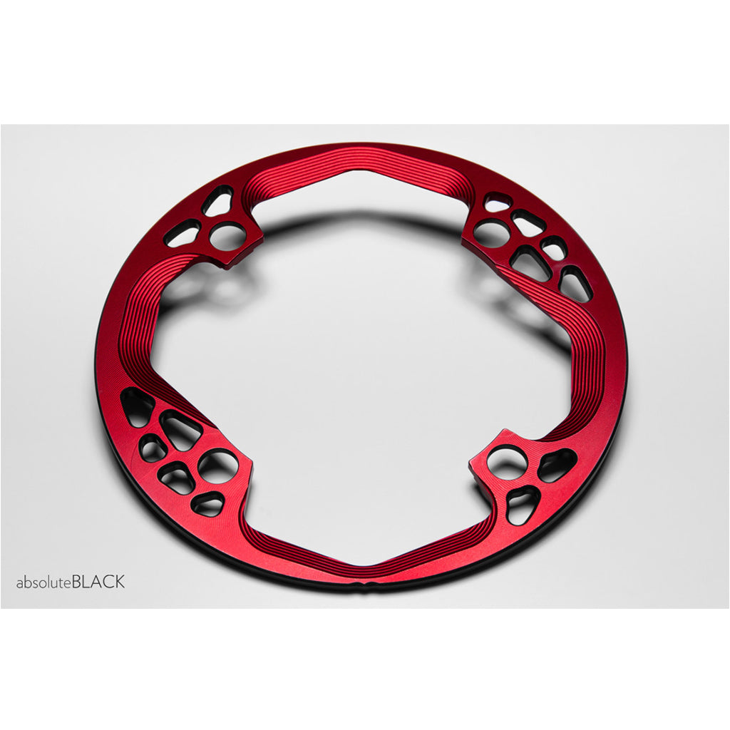 Angled view of the red Absolute Black Bashring 104BCD showing its machined profile.