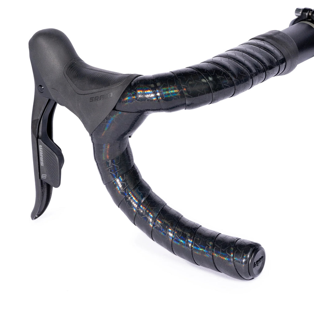 GUEE Attitude Phantom Black bartape on a bicycle handlebar, highlighting its eco-friendly, high-performance design.

