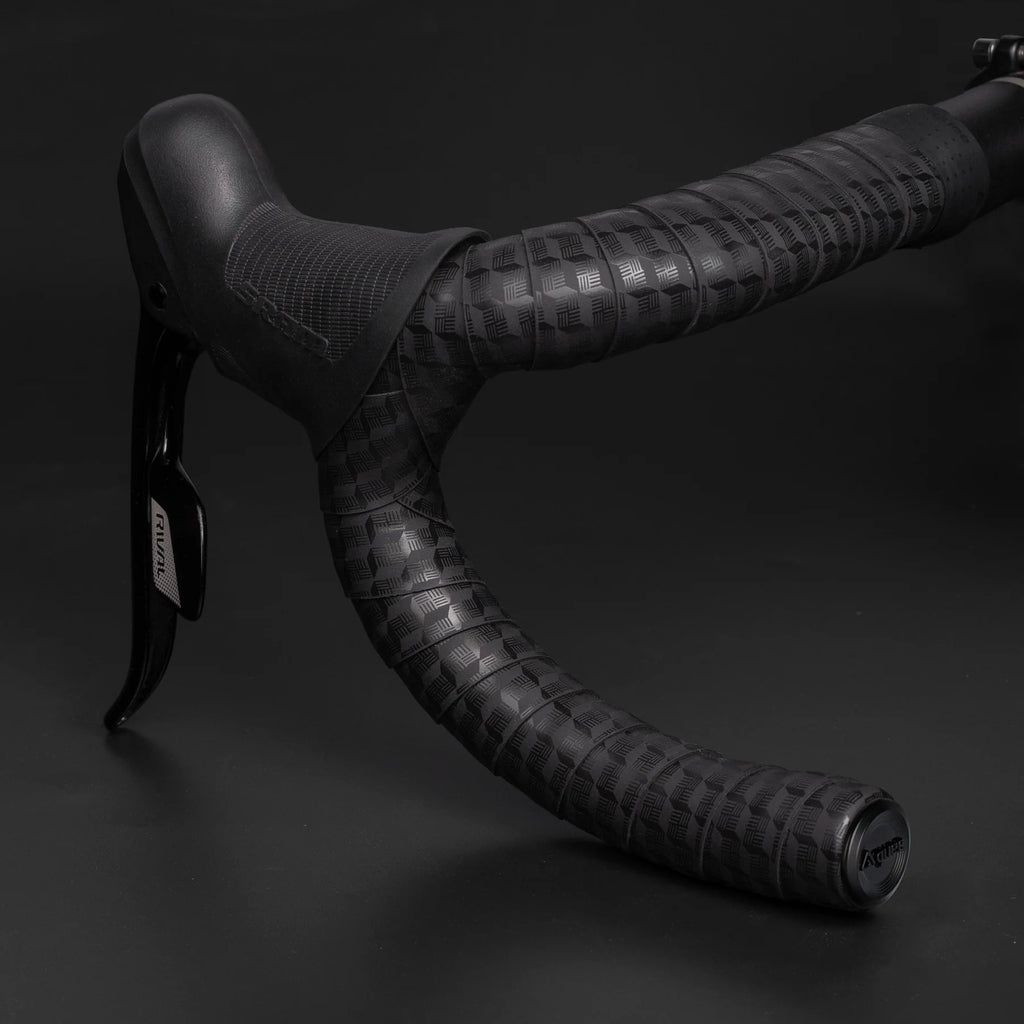 Close-up of GUEE Tornado Black handlebar tape, showcasing the texture for enhanced hand support and comfortable grip.

