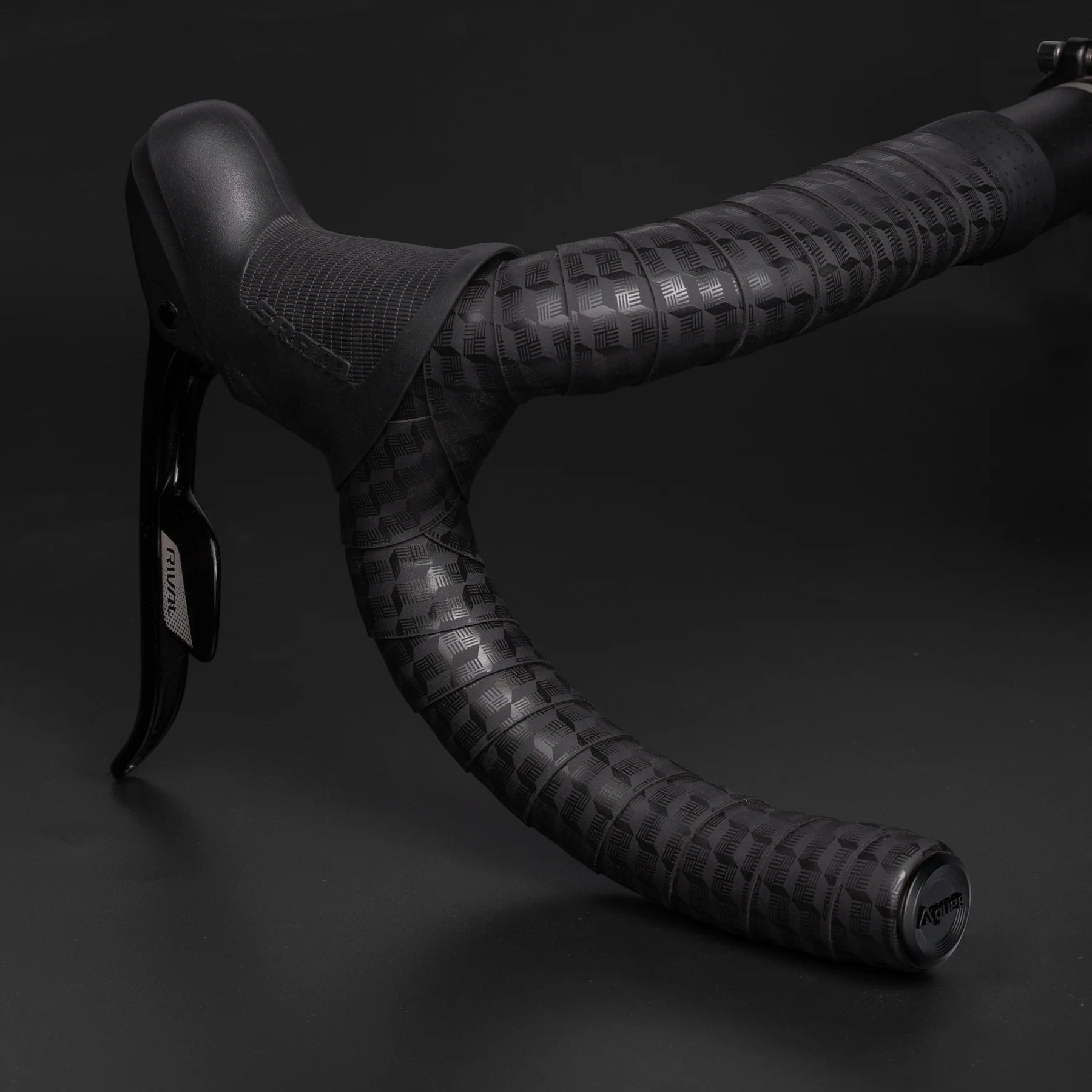 Close-up of GUEE Tornado Black handlebar tape, showcasing the texture for enhanced hand support and comfortable grip.

