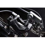 Close-up of the Birzman Piston Release Tool holding back three brake pistons during servicing.