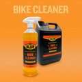 Blub Bike Cleaner 1L trigger-spray bottle shown in front of the 5L jerrycan on an orange background.
