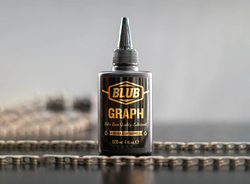 Blub Graph 120ml lubricant bottle standing upright on a bicycle chain.
