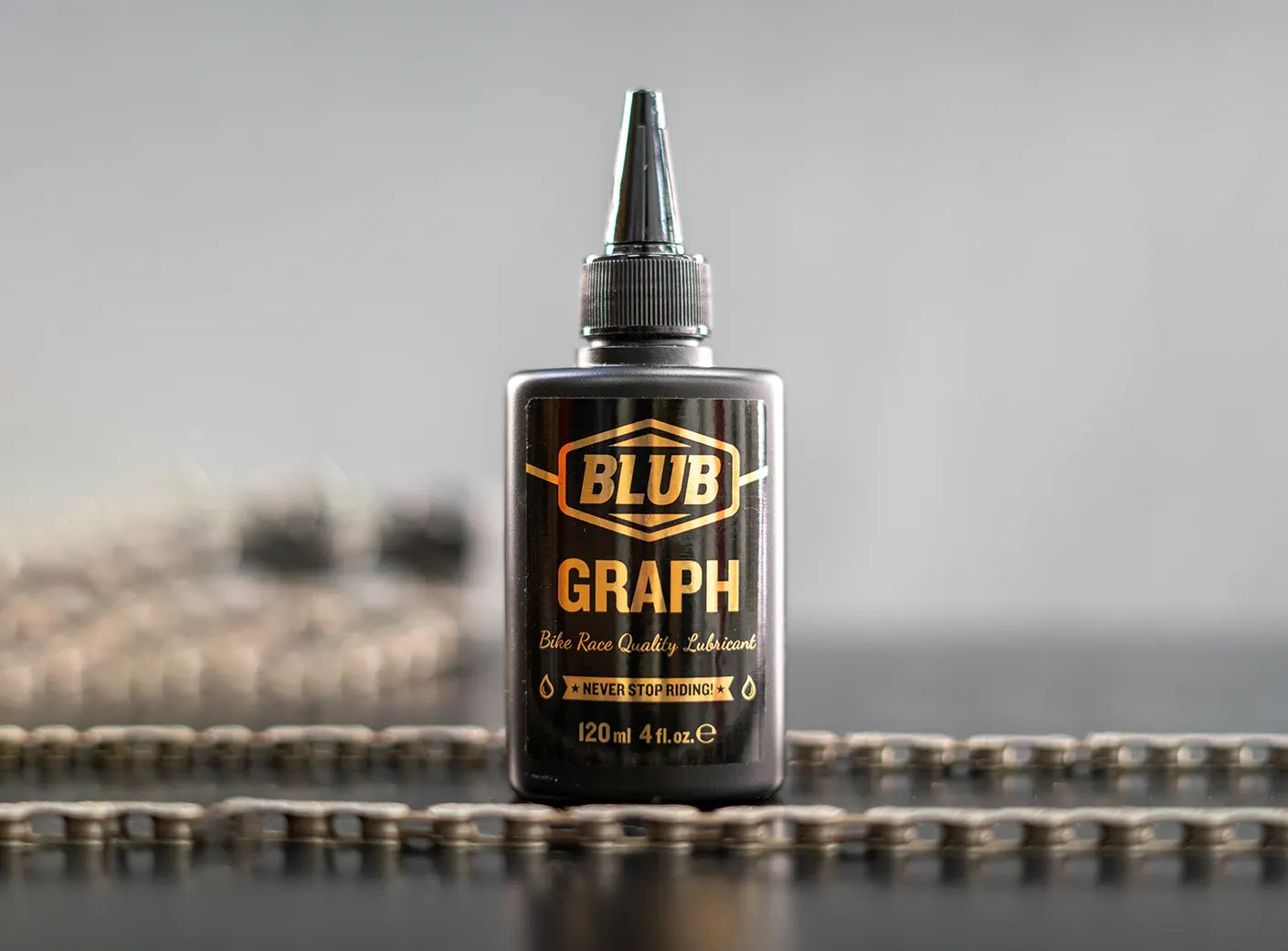 Blub Graph 120ml lubricant bottle standing upright on a bicycle chain.
