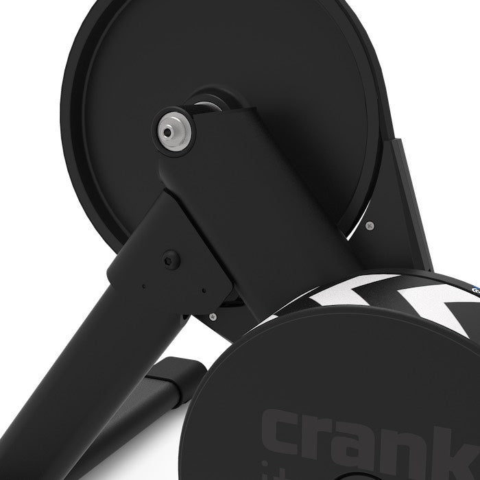 Detail view of the Wahoo KICKR CORE 2's flywheel guard and folding leg hinge showing the simplified four-bolt assembly