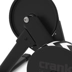 Detail view of the Wahoo KICKR CORE 2's flywheel guard and folding leg hinge showing the simplified four-bolt assembly