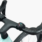 Zwift Click virtual shifter mounted on a drop handlebar alongside the brake lever for the Wahoo KICKR CORE 2