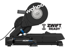 Wahoo KICKR MOVE cycling trainer and a bike from the side, emphasizing the robust steel construction and aerodynamic design for stability.

