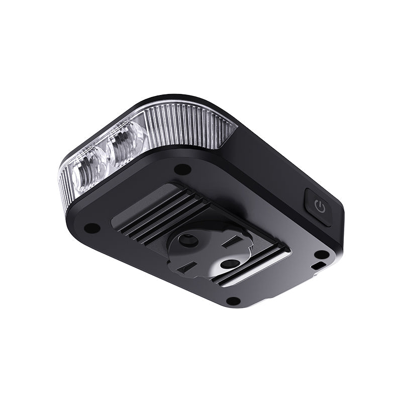 Underside view of the Ravemen FR500 headlight showing the aluminium heat-dissipation fins and power button