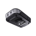 Underside view of the Ravemen FR500 headlight showing the aluminium heat-dissipation fins and power button
