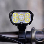 Ravemen PR2400 mounted on a handlebar, illustrating its high-output 2400-lumen beam design.