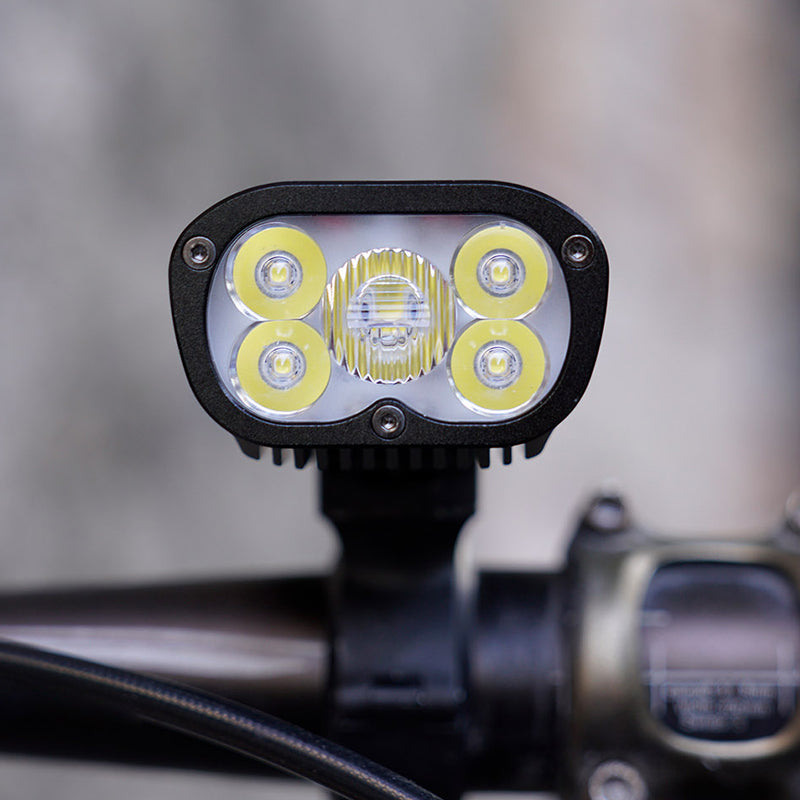 Ravemen PR2400 mounted on a handlebar, illustrating its high-output 2400-lumen beam design.