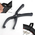 RideNow Tyre Pliers positioned on a bicycle wheel during tyre installation.