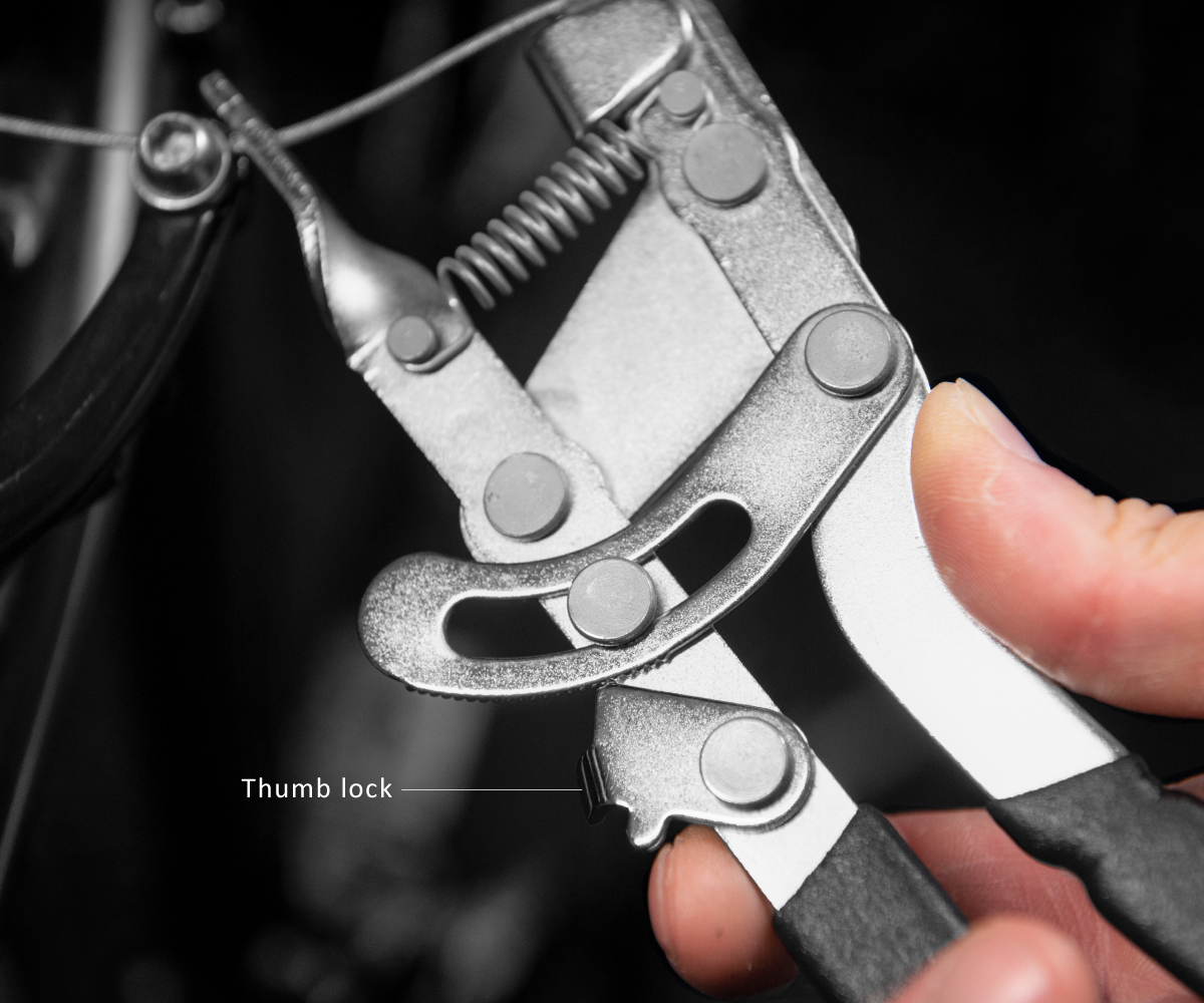 A close-up of the Birzman Cable Pliers thumb lock, a feature that frees up the user's other hand to tighten bolts.