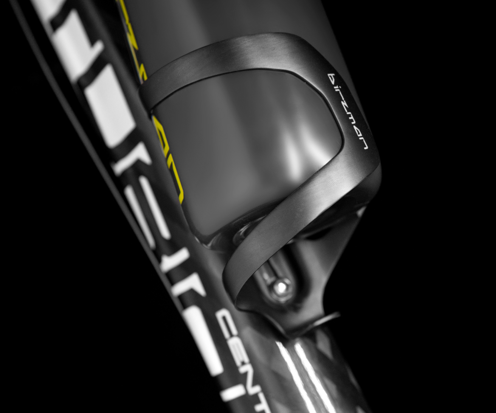 The Birzman Uncage Carbon Bottle Cage (right side), an ultra-lightweight cage for easy bottle removal while riding.