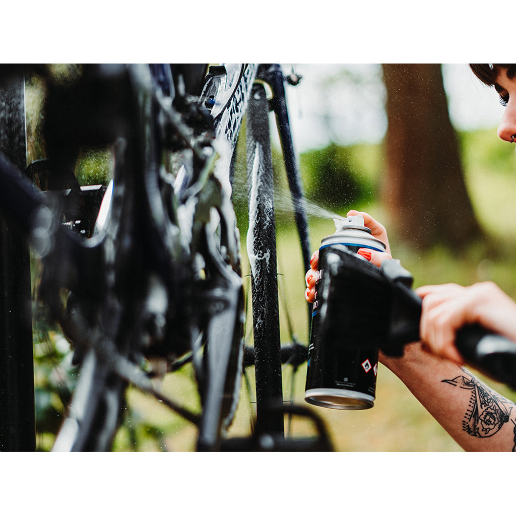 Image of Dynamic Dirt Destroy Foam Spray (400ml) on a bicycle, demonstrating its foaming action for a deep, scratch-free clean.