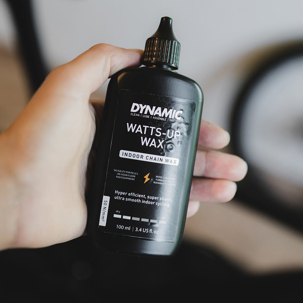 Close-up of Dynamic Watts-Up Wax - Indoor Wax (100ml), highlighting its formula optimized for reducing friction on indoor trainers.