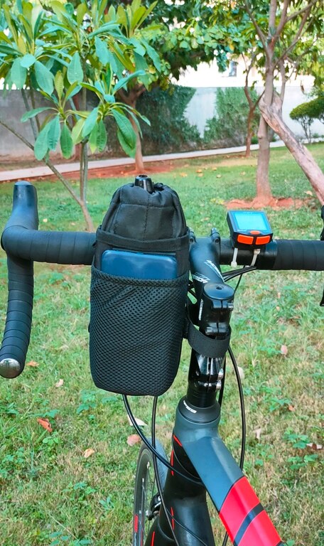 Trek N Ride Cycle Handlebar Bottle & Mobile Pouch attached to a bike, holding a water bottle and smartphone.

