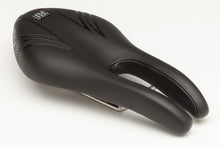 Black ISM PL 1.0 performance long saddle. This nose-less bike seat is 275mm long and 135mm wide, providing comfort and support for high-performance cycling.

