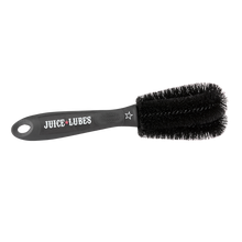 A Juice Lubes Double Ender brush, an essential tool with a two-pronged design for precision cleaning of bicycle cogs and derailleur pulleys.