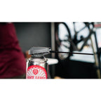 Juice Lubes JL69 Moisture & Protection Spray (400ml) on a bicycle chain, demonstrating its ability to lubricate and repel water.